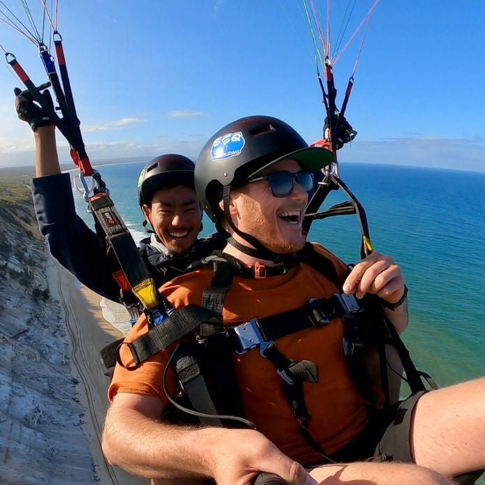 Tandem Paragliding With A Friend: 20 Min Tandem Paragliding & Neck Buffs - We Wander